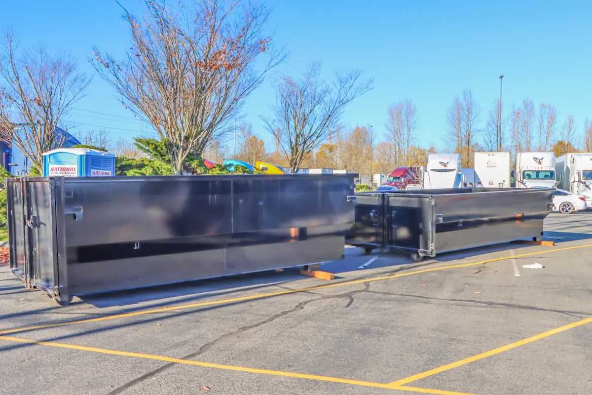 Professional dumpster rental service with roll-off container on residential driveway in Northvale